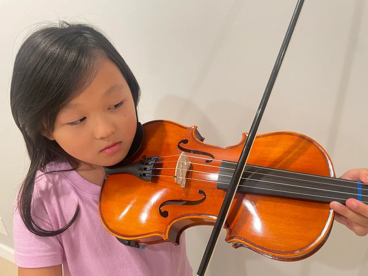 A young student practicing the violin